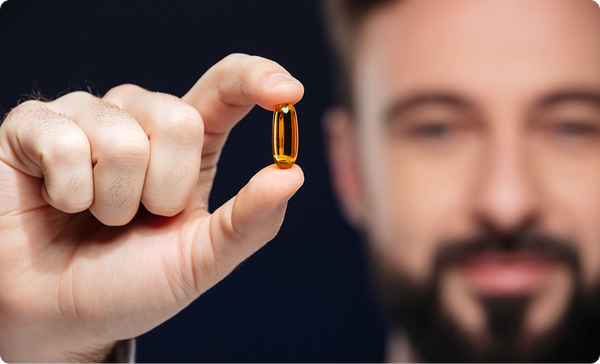 Man holding a softgel